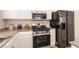 Close-up of a kitchen featuring stainless steel appliances, granite countertops, and white cabinets at 9001 Picket Fence Ave, Las Vegas, NV 89143
