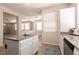 Spacious kitchen featuring an island, granite countertops, stainless steel appliances, and tile flooring at 9001 Picket Fence Ave, Las Vegas, NV 89143