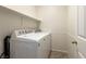 Bright laundry room featuring a white Maytag washer and dryer and ample shelving space at 9001 Picket Fence Ave, Las Vegas, NV 89143