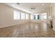 Open-concept living room with tile floors, neutral walls, and bright windows at 9001 Picket Fence Ave, Las Vegas, NV 89143