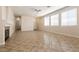 Expansive living room featuring tile flooring, neutral walls, and lots of natural light at 9001 Picket Fence Ave, Las Vegas, NV 89143