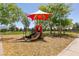 Fun playground with a red shade cover, slide, and climbing area for children at 9001 Picket Fence Ave, Las Vegas, NV 89143