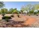Scenic walking path meandering through lush landscaping and mature trees in a vibrant community at 9001 Picket Fence Ave, Las Vegas, NV 89143