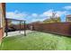 Spacious backyard with green turf, BBQ, hardscape and block wall at 9335 Tonkawa Ave, Las Vegas, NV 89178
