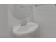 Simple bathroom features a pedestal sink with chrome fixtures and a round mirror at 9335 Tonkawa Ave, Las Vegas, NV 89178