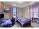 Bedroom featuring a desk and a blue cartoon themed bedspread at 9335 Tonkawa Ave, Las Vegas, NV 89178