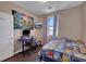 Bedroom with a desk and a blue cartoon themed bedspread at 9335 Tonkawa Ave, Las Vegas, NV 89178