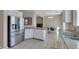 Open-concept kitchen with stainless steel refrigerator, and views to dining area at 9335 Tonkawa Ave, Las Vegas, NV 89178