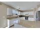 Spacious kitchen boasts granite countertops, stainless steel appliances, and ample white cabinetry at 9335 Tonkawa Ave, Las Vegas, NV 89178
