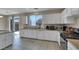 Well-lit kitchen with modern appliances, granite countertops, and sliding door to backyard at 9335 Tonkawa Ave, Las Vegas, NV 89178