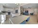 Open concept kitchen, dining, and living room with hardwood floors and neutral walls at 9335 Tonkawa Ave, Las Vegas, NV 89178