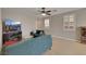 Living room with hardwood floors, a ceiling fan, and a tv on a modern console at 9335 Tonkawa Ave, Las Vegas, NV 89178