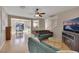 Living room with hardwood floors, a ceiling fan, and a tv on a modern console at 9335 Tonkawa Ave, Las Vegas, NV 89178