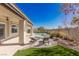 Relaxing backyard with a covered patio, a built-in spa, lounge chairs, and low maintenance landscaping at 9421 Queen Charlotte Dr, Las Vegas, NV 89145