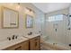 Contemporary bathroom with double vanity, walk-in shower, and sleek fixtures at 9421 Queen Charlotte Dr, Las Vegas, NV 89145