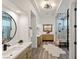 Contemporary bathroom with dual vanities, a frameless glass shower, modern lighting, and wood look flooring at 9421 Queen Charlotte Dr, Las Vegas, NV 89145
