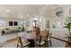 Bright, open concept dining and living room area featuring stylish decor and an abundance of natural light at 9421 Queen Charlotte Dr, Las Vegas, NV 89145