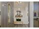 Elegant entryway with decorative front door, soaring ceilings, and a view into a beautifully decorated dining area at 9421 Queen Charlotte Dr, Las Vegas, NV 89145