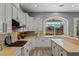 Bright kitchen featuring white cabinets, stainless steel appliances, and a large window with a scenic view at 9421 Queen Charlotte Dr, Las Vegas, NV 89145