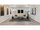 Cozy living room showcases modern decor, natural stone accent wall, and plush seating at 9421 Queen Charlotte Dr, Las Vegas, NV 89145