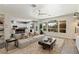Inviting living room with plush rug, contemporary furniture, and backyard views through expansive windows at 9421 Queen Charlotte Dr, Las Vegas, NV 89145