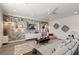 Modern living room featuring a stylish brick wall with floating shelves, recessed lighting, and a plush area rug at 9421 Queen Charlotte Dr, Las Vegas, NV 89145