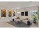 Inviting living room with stone accent walls, modern seating, and large windows at 9421 Queen Charlotte Dr, Las Vegas, NV 89145