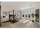 Inviting bedroom with a four-poster bed, French doors to the pool, and stylish decor at 9421 Queen Charlotte Dr, Las Vegas, NV 89145