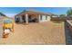 Low maintenance backyard with gravel, brick patio, and privacy wall perfect for outdoor enjoyment and relaxation at 9431 S Tee Pee Ln, Las Vegas, NV 89178
