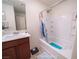 Bathroom featuring a shower-tub combination with tiled walls and a single sink at 9431 S Tee Pee Ln, Las Vegas, NV 89178