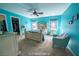 Primary bedroom featuring blue walls, a ceiling fan, a queen sized bed, and a walk-in closet at 9431 S Tee Pee Ln, Las Vegas, NV 89178