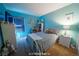 Bright bedroom with light blue walls, carpet, a full sized bed, and ample natural light at 9431 S Tee Pee Ln, Las Vegas, NV 89178