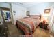 Comfortable bedroom with a queen-sized bed, carpeted floors, and a glimpse into the next room at 9431 S Tee Pee Ln, Las Vegas, NV 89178