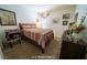 Cozy bedroom featuring a queen-sized bed, a wooden dresser, and carpeted floors at 9431 S Tee Pee Ln, Las Vegas, NV 89178