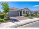 Well-maintained single-story home featuring a tile roof, a brick-paved driveway, and manicured landscaping in a desirable neighborhood at 9431 S Tee Pee Ln, Las Vegas, NV 89178