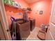 Efficient laundry room with modern front-loading washer and dryer, ample shelving, and stylish decor for easy chores at 9431 S Tee Pee Ln, Las Vegas, NV 89178