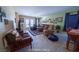 Inviting living room with comfortable seating, including recliners, complemented by a classic rug and sunlit windows at 9431 S Tee Pee Ln, Las Vegas, NV 89178