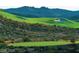 Beautiful golf course with manicured greens and sand traps, set against a backdrop of rolling hills at , Henderson, NV 89012