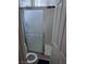Bathroom featuring a glass door shower enclosure with white tiled walls and a white toilet at 10023 Liberty View Rd, Las Vegas, NV 89148