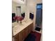 Bathroom featuring double sinks, wooden vanity, framed mirror, and a separate enclosed shower at 10023 Liberty View Rd, Las Vegas, NV 89148