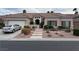 Charming single-story home featuring a well-manicured front yard and a two-car garage at 10023 Liberty View Rd, Las Vegas, NV 89148