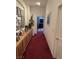 Inviting hallway with a carpet runner, built-in wooden cabinets, and Gathering photos displayed at 10023 Liberty View Rd, Las Vegas, NV 89148