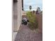 Narrow side yard landscaped with decorative rock and bushes, featuring an air conditioning unit at 10023 Liberty View Rd, Las Vegas, NV 89148