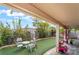 Charming backyard with covered patio, well-maintained turf, and lush landscaping creates a serene outdoor oasis at 10143 Canyon Hills Ave, Las Vegas, NV 89148