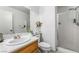 Clean bathroom featuring a single sink vanity, toilet, shower and white paint at 10143 Canyon Hills Ave, Las Vegas, NV 89148