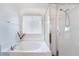 Bright white bathroom with a tub and glass-enclosed shower at 10143 Canyon Hills Ave, Las Vegas, NV 89148