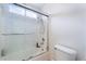 Bright bathroom featuring tiled shower with glass door, with a shower head and a toilet on the side at 10143 Canyon Hills Ave, Las Vegas, NV 89148