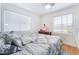 Well-lit bedroom featuring a comfortable bed and bright windows at 10143 Canyon Hills Ave, Las Vegas, NV 89148