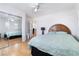 Bright bedroom featuring hardwood floors, windows, and sliding mirror closet at 10143 Canyon Hills Ave, Las Vegas, NV 89148