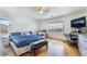 Bright bedroom featuring a modern bed frame, hardwood floors and a ceiling fan at 10143 Canyon Hills Ave, Las Vegas, NV 89148